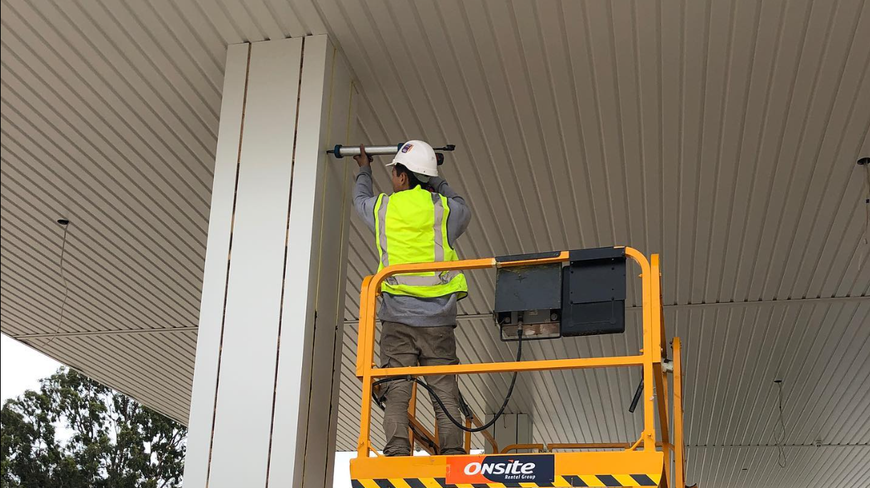 Gapless caulker sealing facade panel joints from an EWP on a commercial site in Melbourne