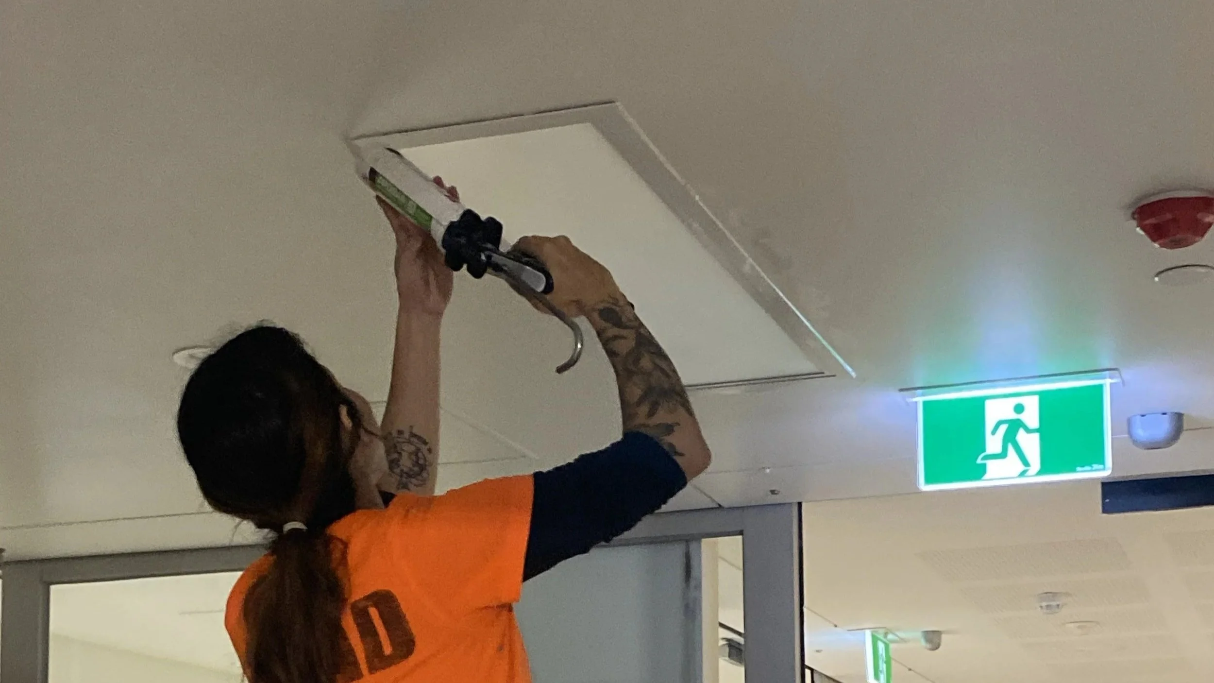Sealing ceiling panel junctions in a commercial corridor, Melbourne